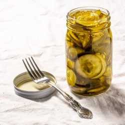 dill pickles in a jar with fork